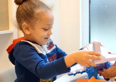 Autistic child playing with his plane toy during an ABA therapy session