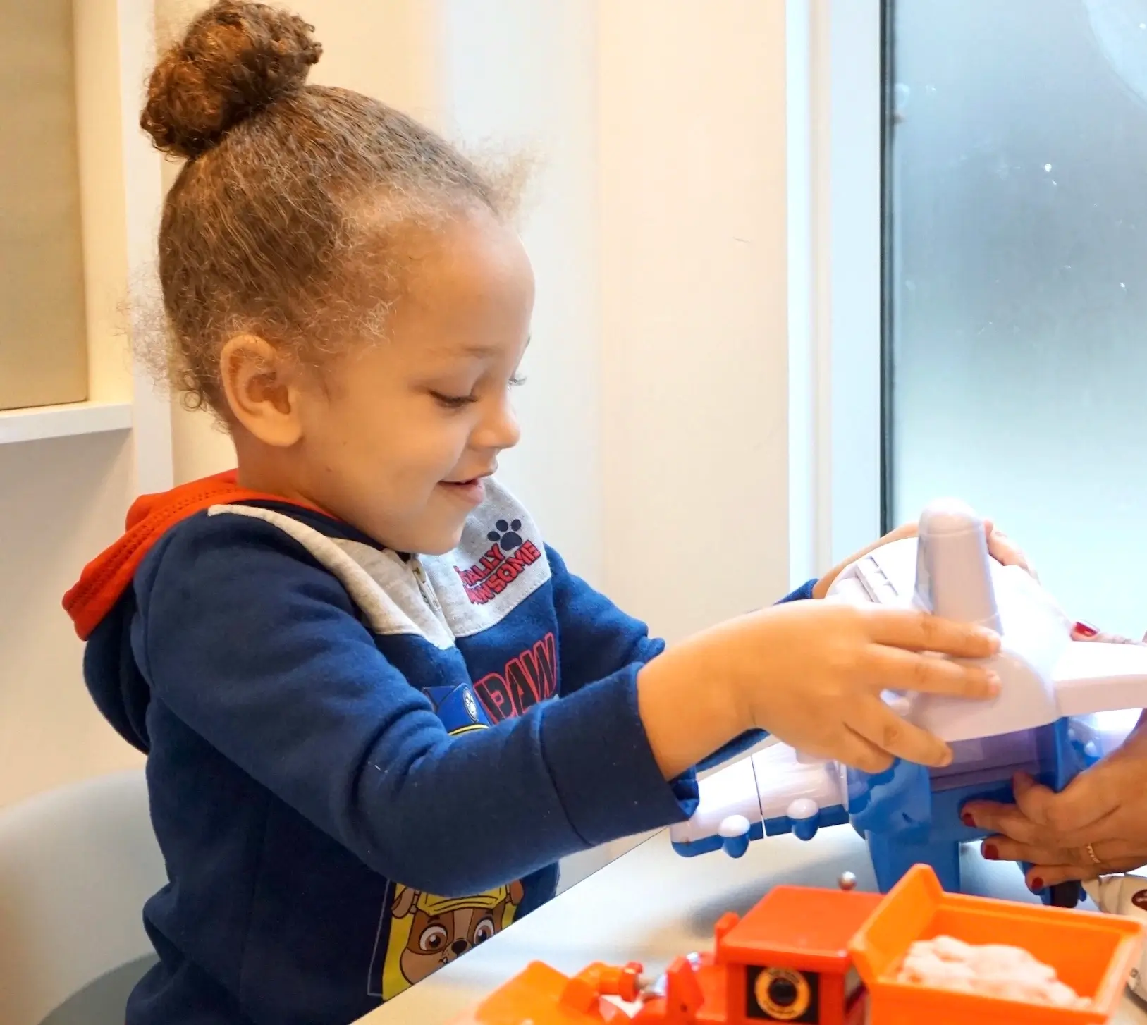 Autistic child playing with his plane toy during an ABA therapy session